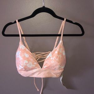 A pink and white XL bathing suit top.